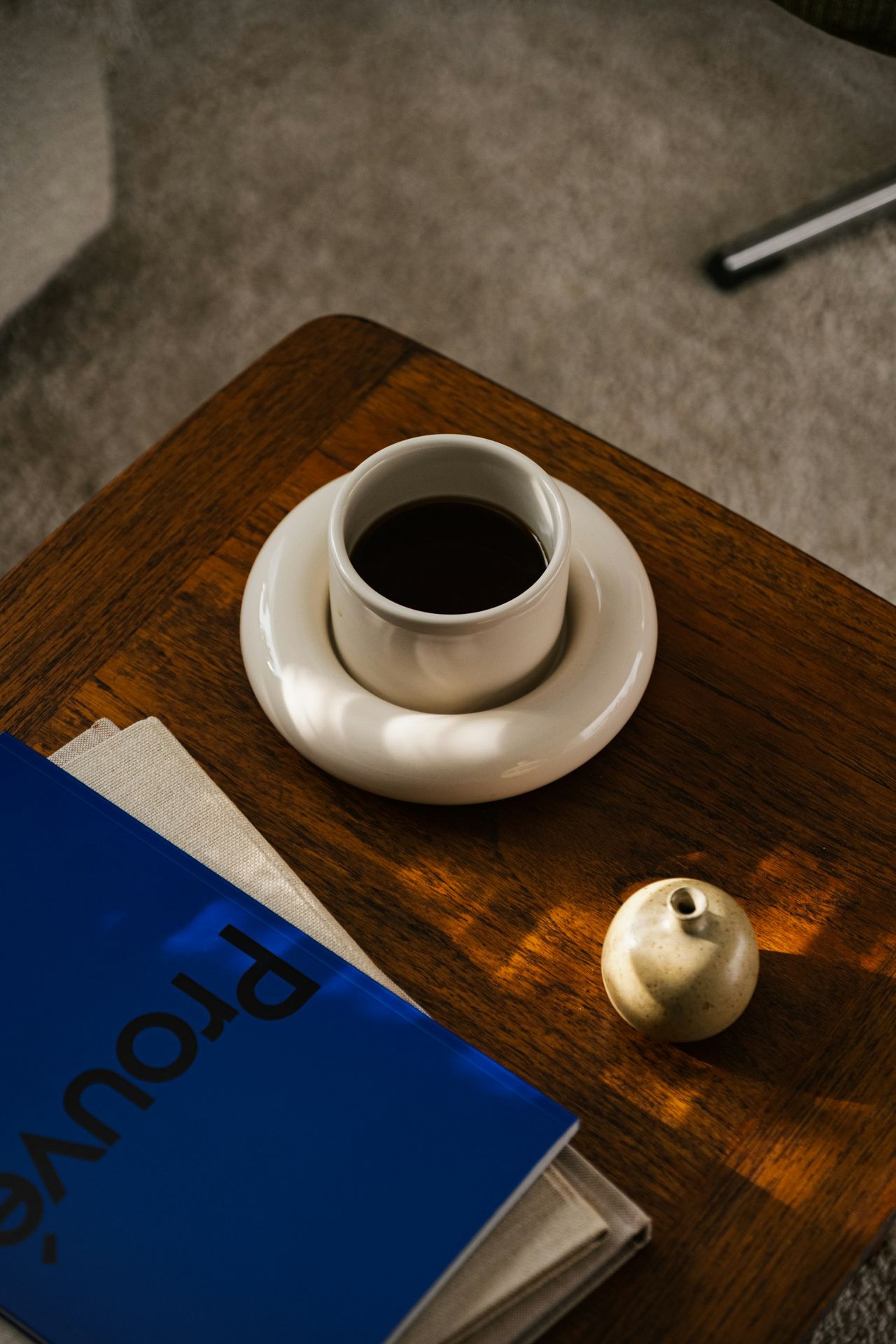 a cup of coffee and a book on a table